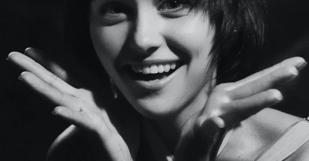 Female Pose Reference: A Guide to Capturing Feminine Forms 2024 111 smiling woman in black and white as a female pose reference