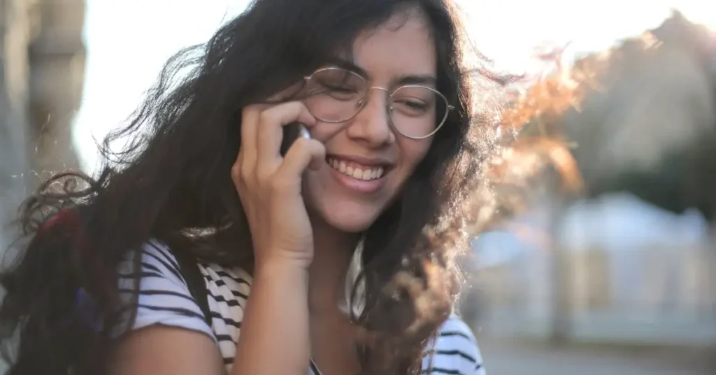Drawing Hairstyles Ideas: Inspiration for Sketching Trendy Hairdos 2024 11 woman with curly hair on the phone as drawing hairstyles ideas